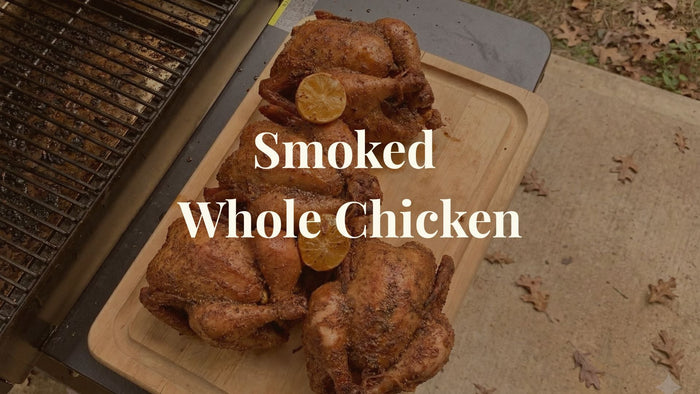 Whole Chickens on a cutting board, sitting next to a Traeger smoker