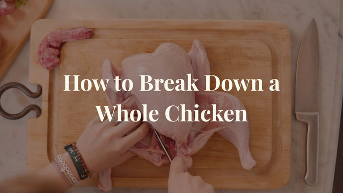 A whole chicken on a cutting board with the overlay text - How to Break Down a Whole Chicken